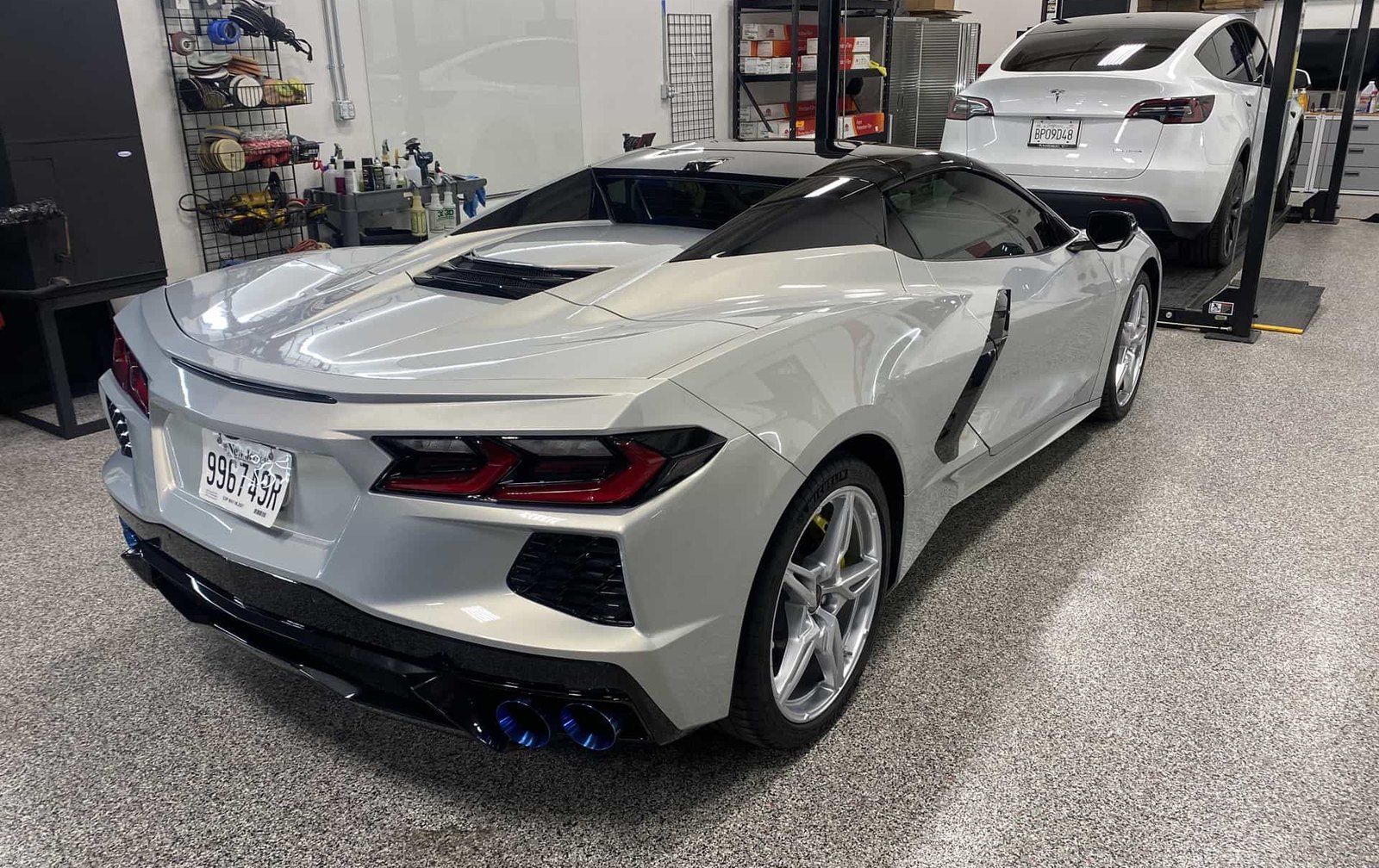 Corvette and other customer vehicles inside the Detail 2 U shop in Rancho Cucamonga